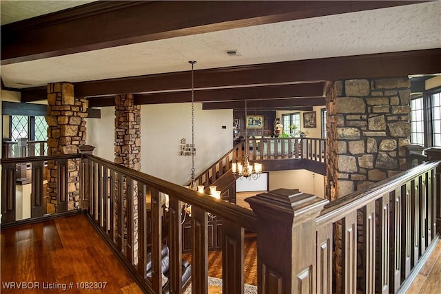 3417 Royal Scots Way, Fort Smith, AR 72908 - stairs featuring wood-type flooring, beam ceiling, a textured ceiling, a chandelier, and decorative columns