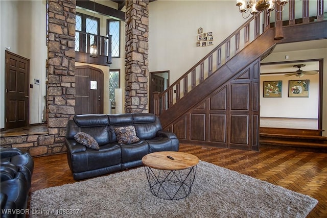 3417 Royal Scots Way, Fort Smith, AR 72908 - living area with decorative columns, a high ceiling, a chandelier, stairway, and a ceiling fan