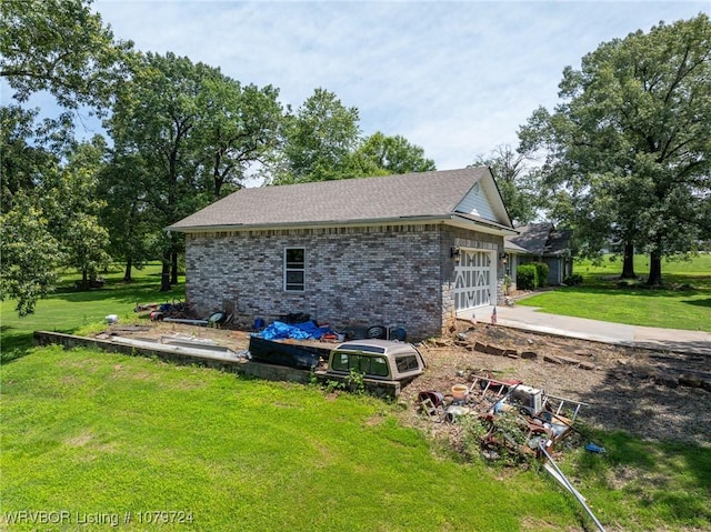 2702 Rambo Cir, Lavaca, AR 72941 - view of side of home with a yard, brick siding, an attached garage, and roof with shingles