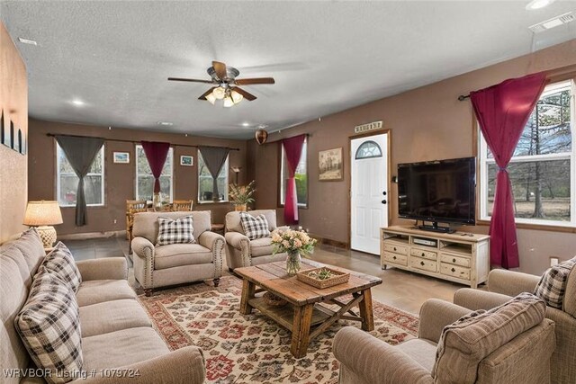 2702 Rambo Cir, Lavaca, AR 72941 - living area with crown molding, a tray ceiling, a ceiling fan, wainscoting, and wood finished floors