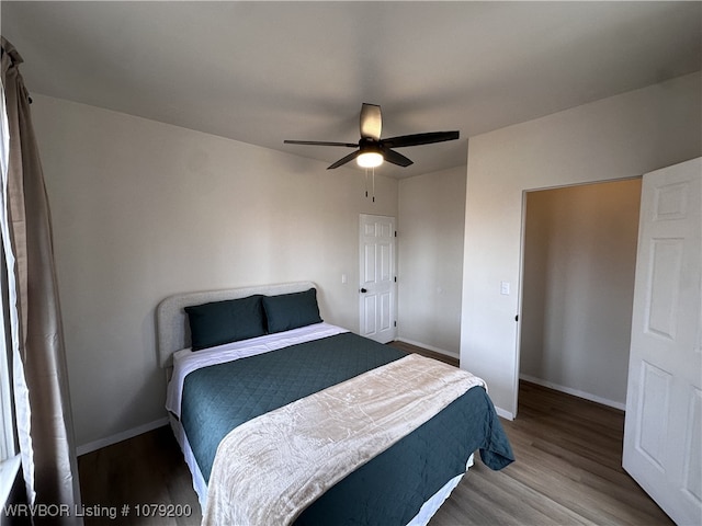 bedroom featuring ceiling fan, wood finished floors, and baseboards