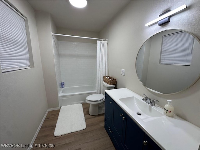 bathroom with toilet, shower / bath combo, vanity, wood finished floors, and baseboards