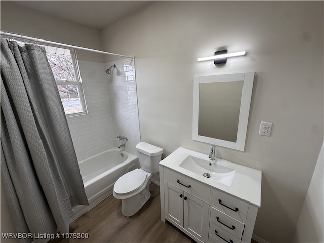 full bathroom with vanity, wood finished floors, shower / bath combo with shower curtain, and toilet