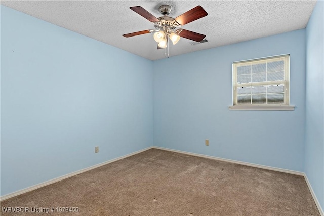 empty room featuring carpet floors, baseboards, visible vents, and a textured ceiling