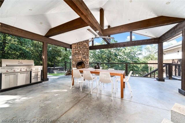 10101 Stephens Ct, Fort Smith, AR 72908 - view of patio featuring an outdoor stone fireplace, outdoor dining area, and exterior kitchen