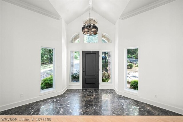 10101 Stephens Ct, Fort Smith, AR 72908 - foyer with plenty of natural light, a chandelier, marble tiled flooring, high vaulted ceiling, and ornamental molding