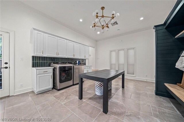 10101 Stephens Ct, Fort Smith, AR 72908 - kitchen featuring washer and dryer, crown molding, white cabinetry, a chandelier, and recessed lighting