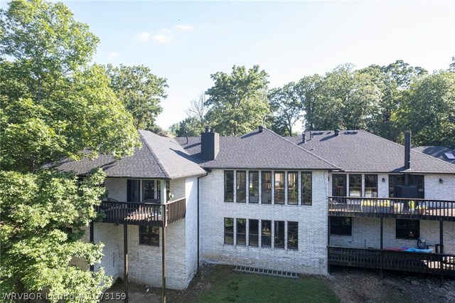 10101 Stephens Ct, Fort Smith, AR 72908 - back of house featuring brick siding, a chimney, a deck, and roof with shingles