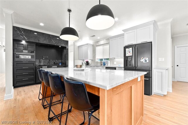 10101 Stephens Ct, Fort Smith, AR 72908 - kitchen with refrigerator with ice dispenser, crown molding, light wood finished floors, light stone counters, and hanging light fixtures