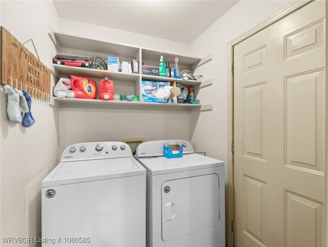 clothes washing area featuring washer and dryer and laundry area