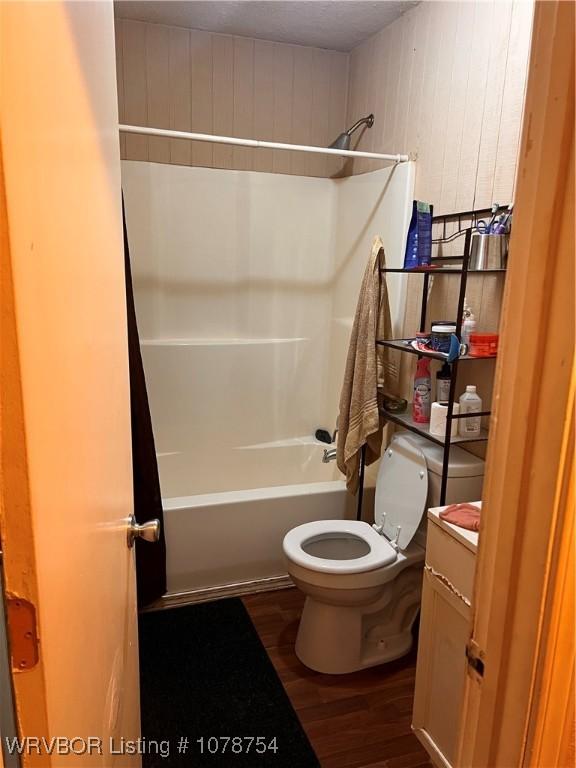 full bathroom featuring vanity, hardwood / wood-style floors, toilet, and shower / bath combination