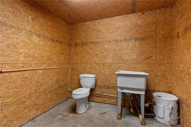 bathroom featuring unfinished concrete floors and toilet