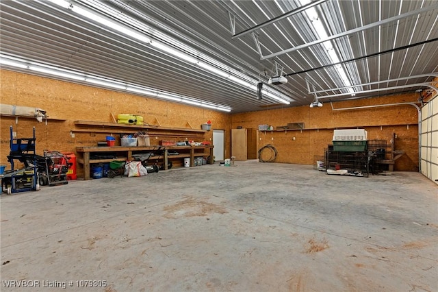 garage with a workshop area and a garage door opener