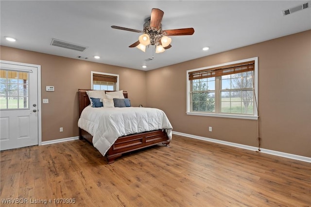 bedroom featuring visible vents, recessed lighting, light wood-type flooring, and baseboards