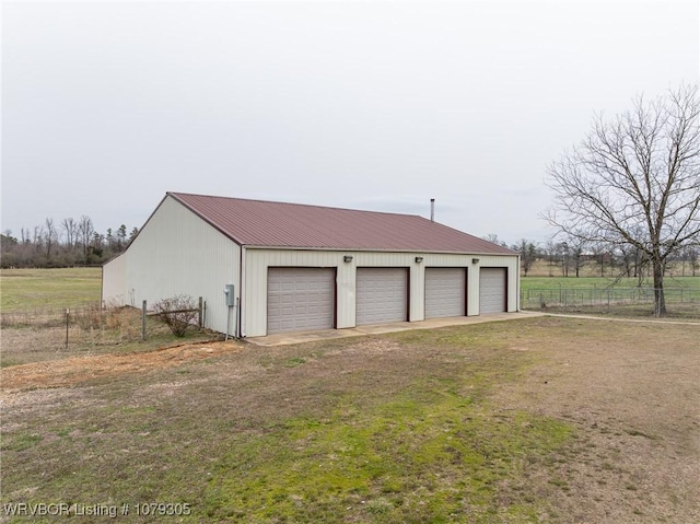 detached garage featuring fence