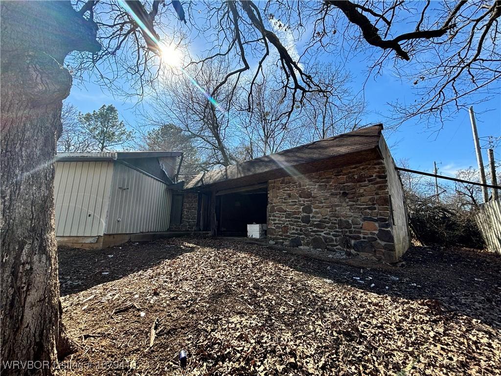 view of side of property with stone siding