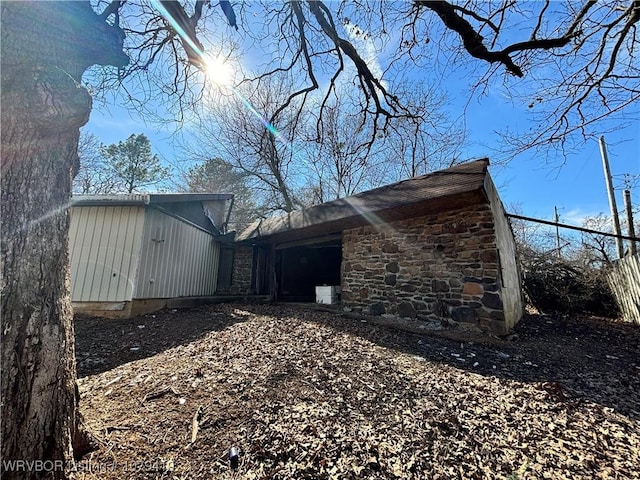 view of side of property with stone siding