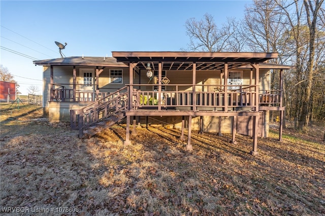 back of property featuring covered porch