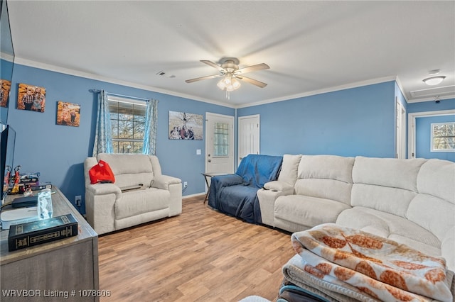 living room with ornamental molding, ceiling fan, and light hardwood / wood-style floors