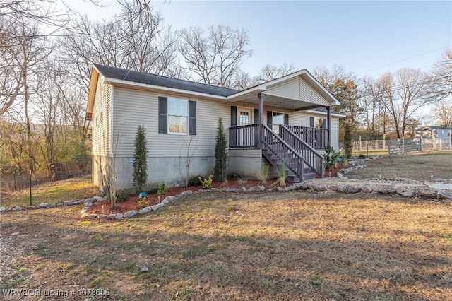 view of front of home with a porch and a front yard