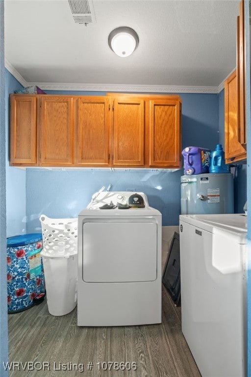 washroom featuring cabinets, ornamental molding, hardwood / wood-style flooring, washer and clothes dryer, and water heater