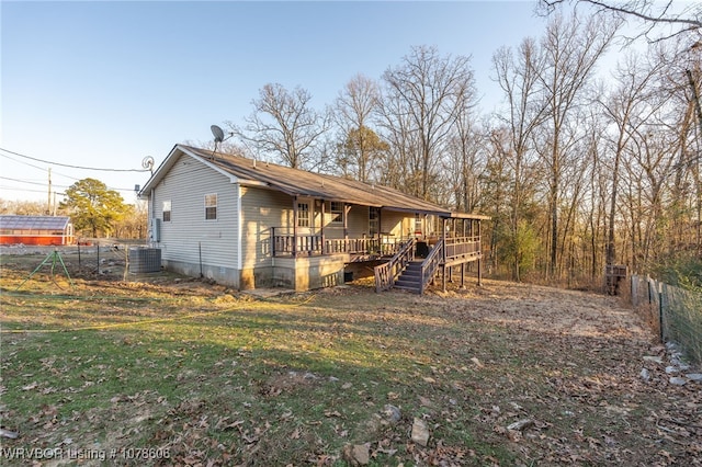 exterior space with cooling unit and a yard