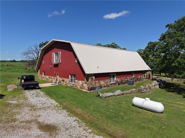 20309 E County Road 1110, Stigler, OK 74462 - view of side of property featuring a gambrel roof, a barn, driveway, an outdoor structure, and a yard