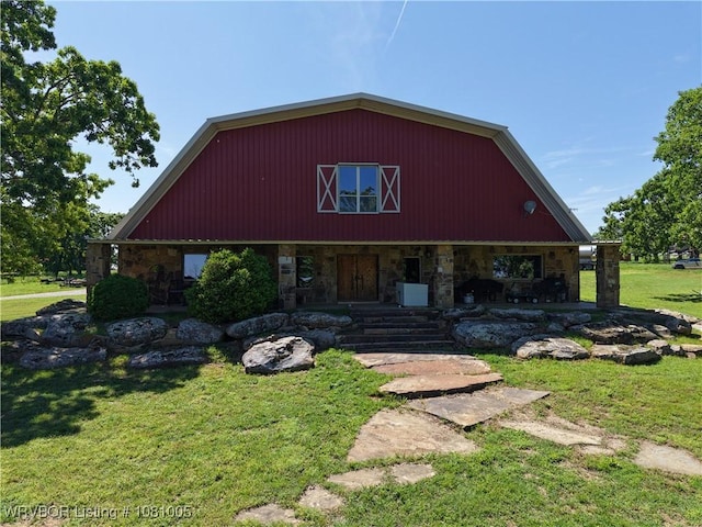 20309 E County Road 1110, Stigler, OK 74462 - view of front facade with stone siding, a front lawn, and covered porch
