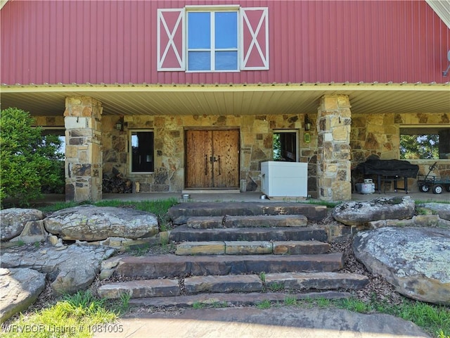 20309 E County Road 1110, Stigler, OK 74462 - view of front facade with stone siding and covered porch