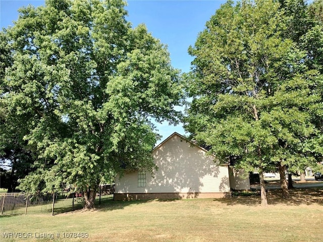 view of property exterior with a yard