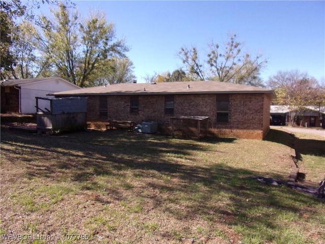 rear view of property with a lawn