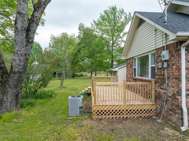 view of yard with a wooden deck and central AC unit