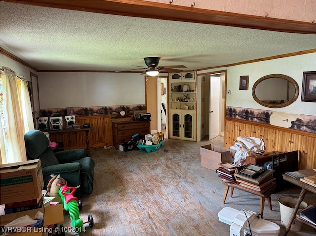 106 E Cedar St, Hackett, AR 72937 - living area with a textured ceiling, crown molding, wood finished floors, wood walls, and a ceiling fan