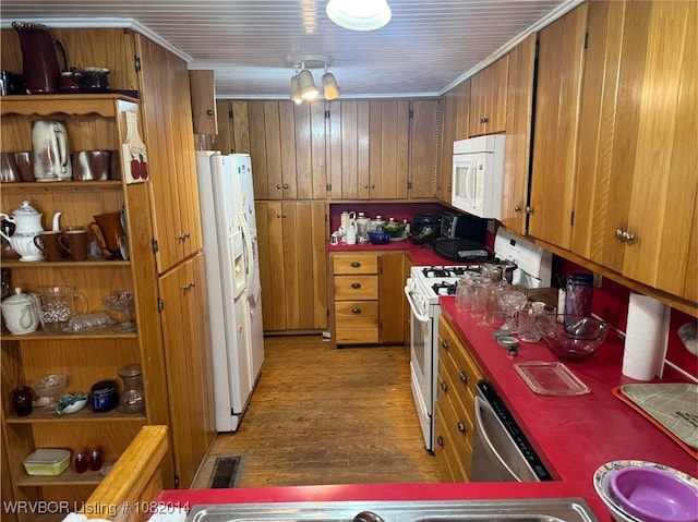 106 E Cedar St, Hackett, AR 72937 - kitchen featuring white appliances, brown cabinetry, light wood-type flooring, and wood walls