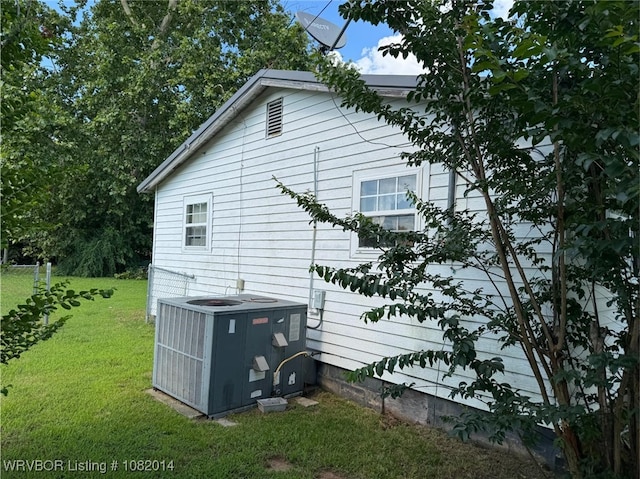 106 E Cedar St, Hackett, AR 72937 - view of property exterior with a central air condition unit and a lawn