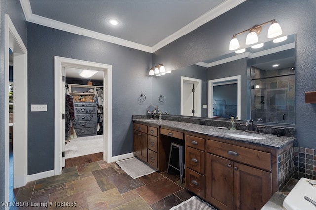 8205 Cisterna Way, Fort Smith, AR 72916 - bathroom featuring a sink, a walk in closet, ornamental molding, a textured wall, and double vanity