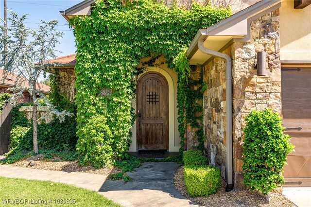 8205 Cisterna Way, Fort Smith, AR 72916 - doorway to property featuring stone siding