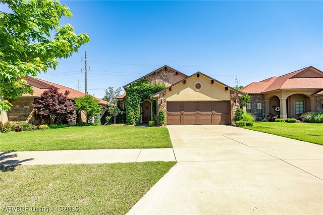 8205 Cisterna Way, Fort Smith, AR 72916 - mediterranean / spanish-style house with a garage, stucco siding, concrete driveway, stone siding, and a front lawn