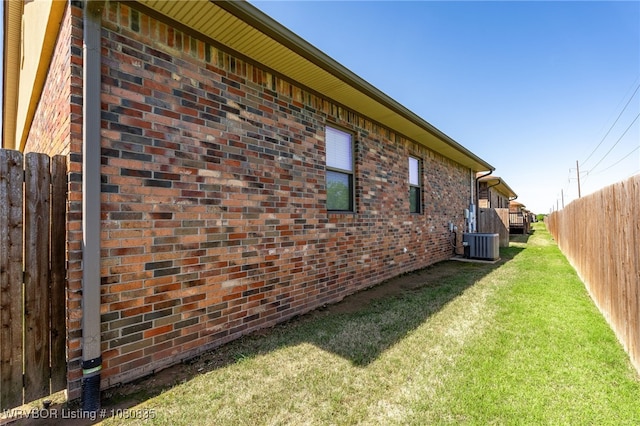 8205 Cisterna Way, Fort Smith, AR 72916 - view of property exterior featuring brick siding, central AC unit, fence, and a lawn