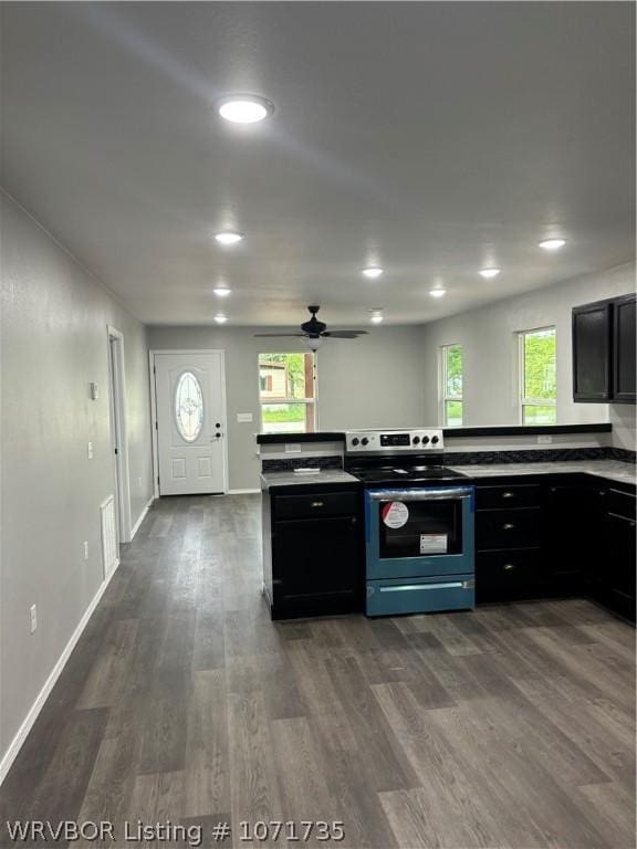 kitchen with stainless steel electric range oven, dark hardwood / wood-style flooring, and ceiling fan