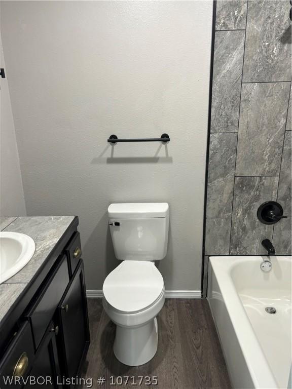 full bathroom featuring hardwood / wood-style floors, vanity, toilet, and shower / bath combination