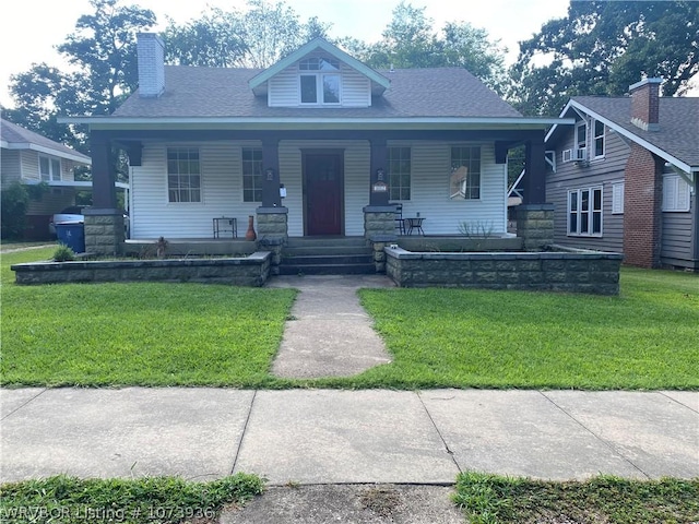 view of front facade with a front yard and a porch