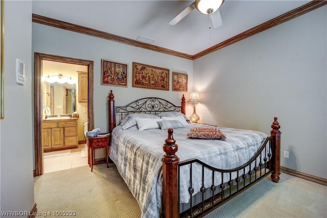 carpeted bedroom featuring ceiling fan, ornamental molding, sink, and connected bathroom