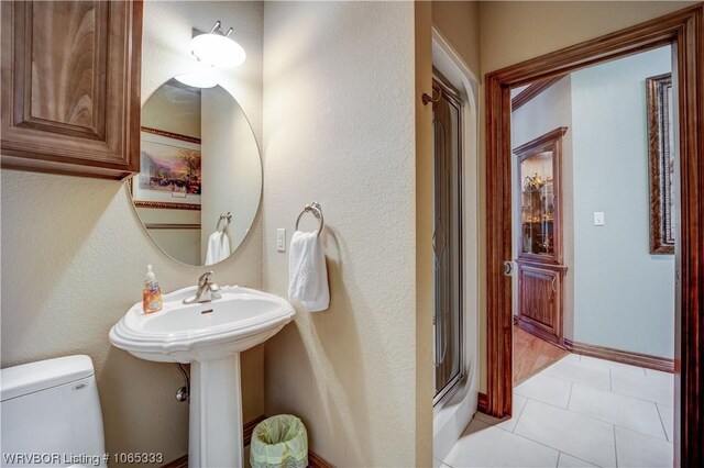 bathroom featuring toilet and tile patterned floors