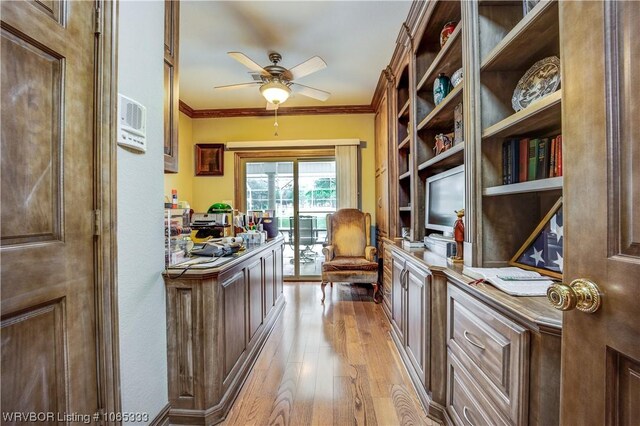 home office with ceiling fan, light hardwood / wood-style flooring, and ornamental molding