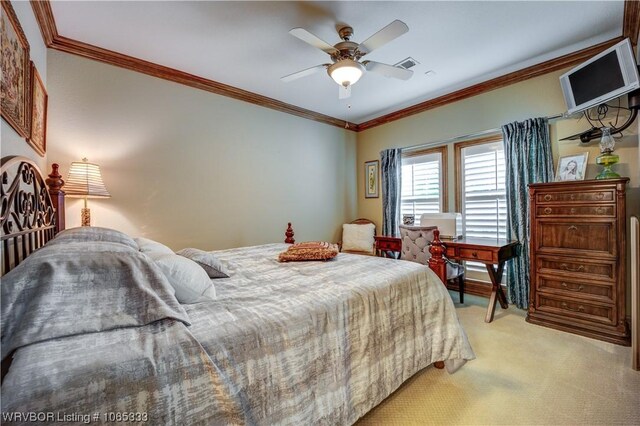 carpeted bedroom with ceiling fan and crown molding