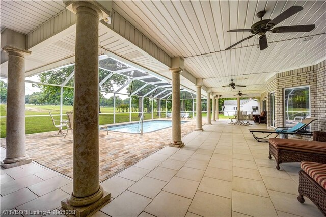 view of patio / terrace with glass enclosure and ceiling fan