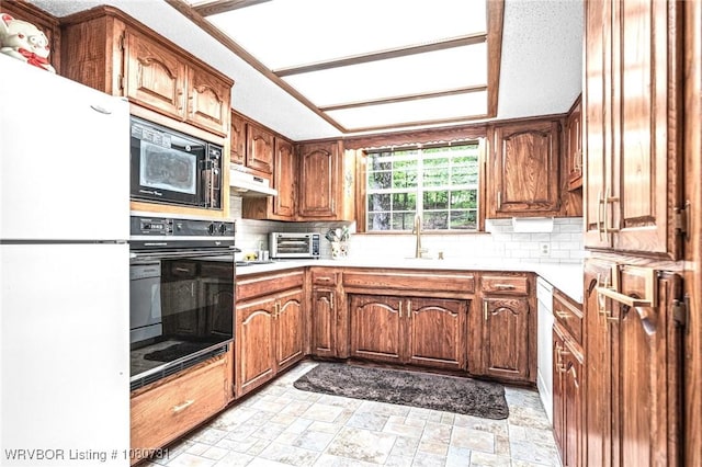 3009 Shadow Lake Dr, Greenwood, AR 72936 - kitchen with a sink, brown cabinetry, backsplash, under cabinet range hood, and black appliances