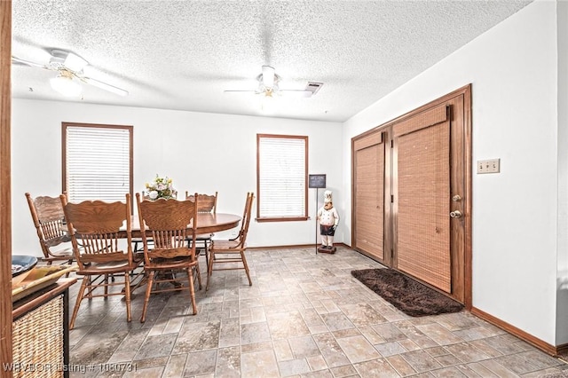 3009 Shadow Lake Dr, Greenwood, AR 72936 - dining room with baseboards, a ceiling fan, and a textured ceiling