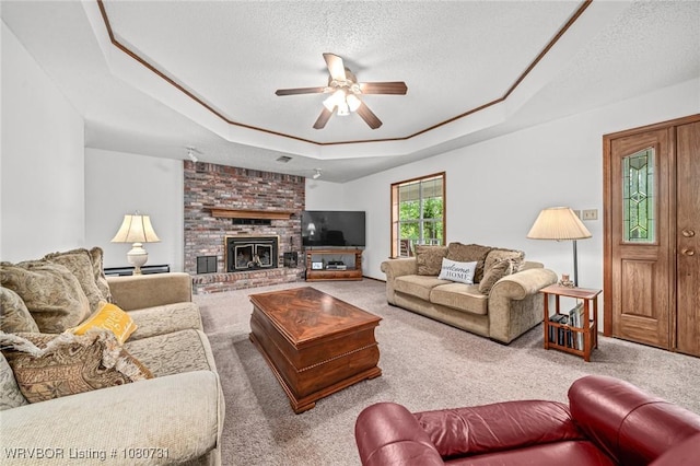 3009 Shadow Lake Dr, Greenwood, AR 72936 - living area featuring ceiling fan, a fireplace, a textured ceiling, carpet, and a tray ceiling